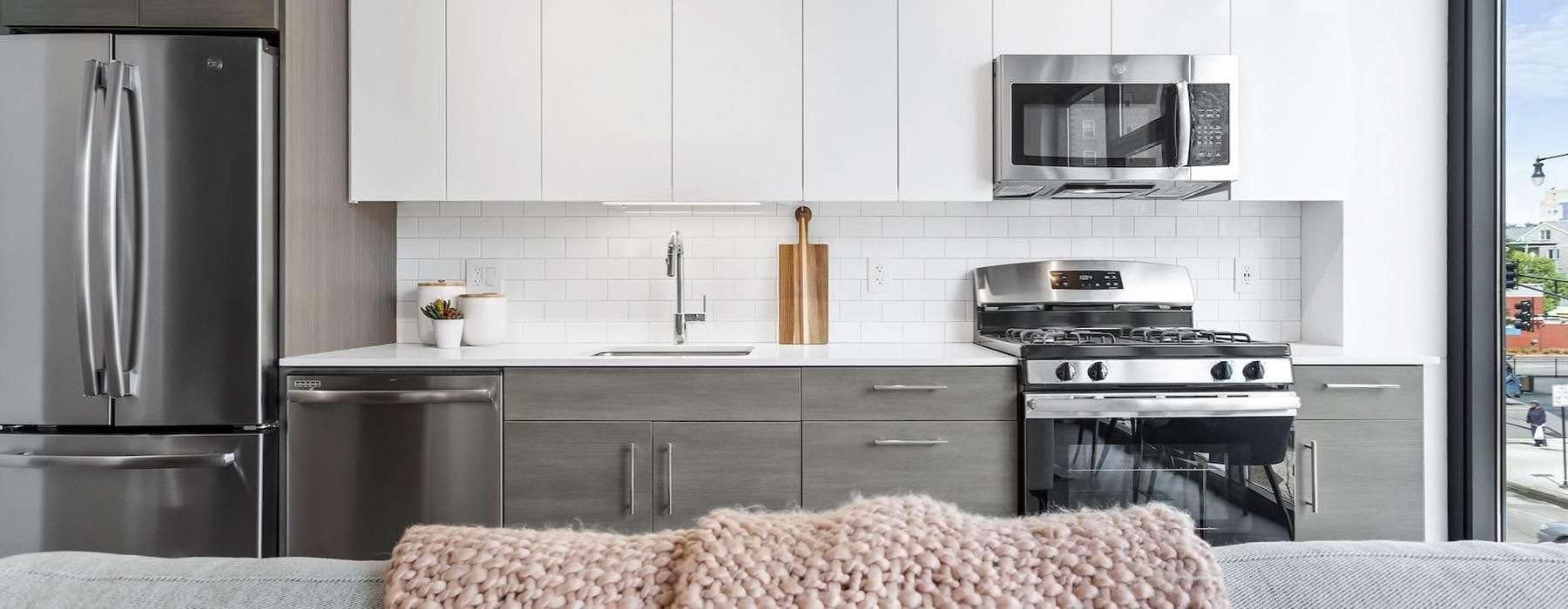 a kitchen with white cabinets
